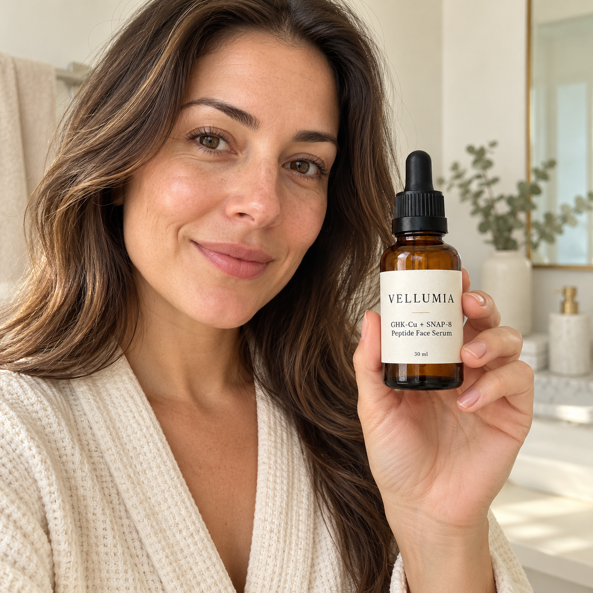 Vellumia GHK-Cu + SNAP-8 serum bottle styled on a warm stone vanity with linen